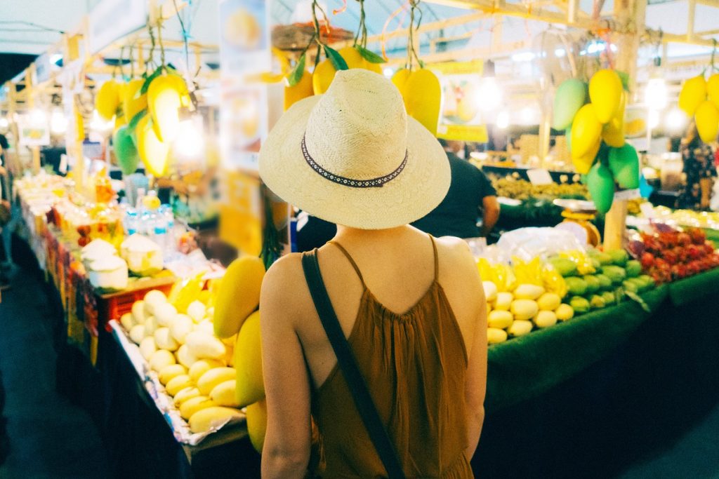 Woman choosing mango in market