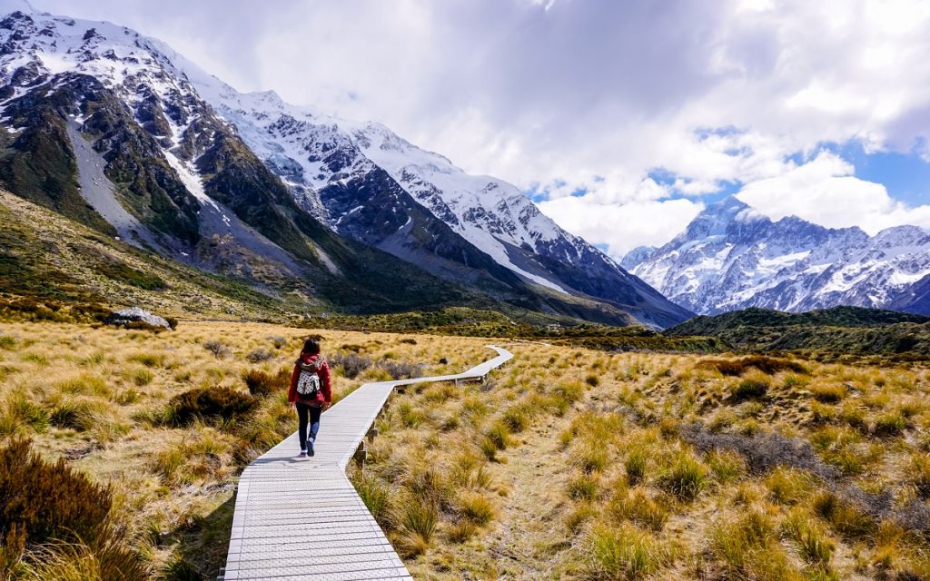 Woman walking through Hooker Valley trail