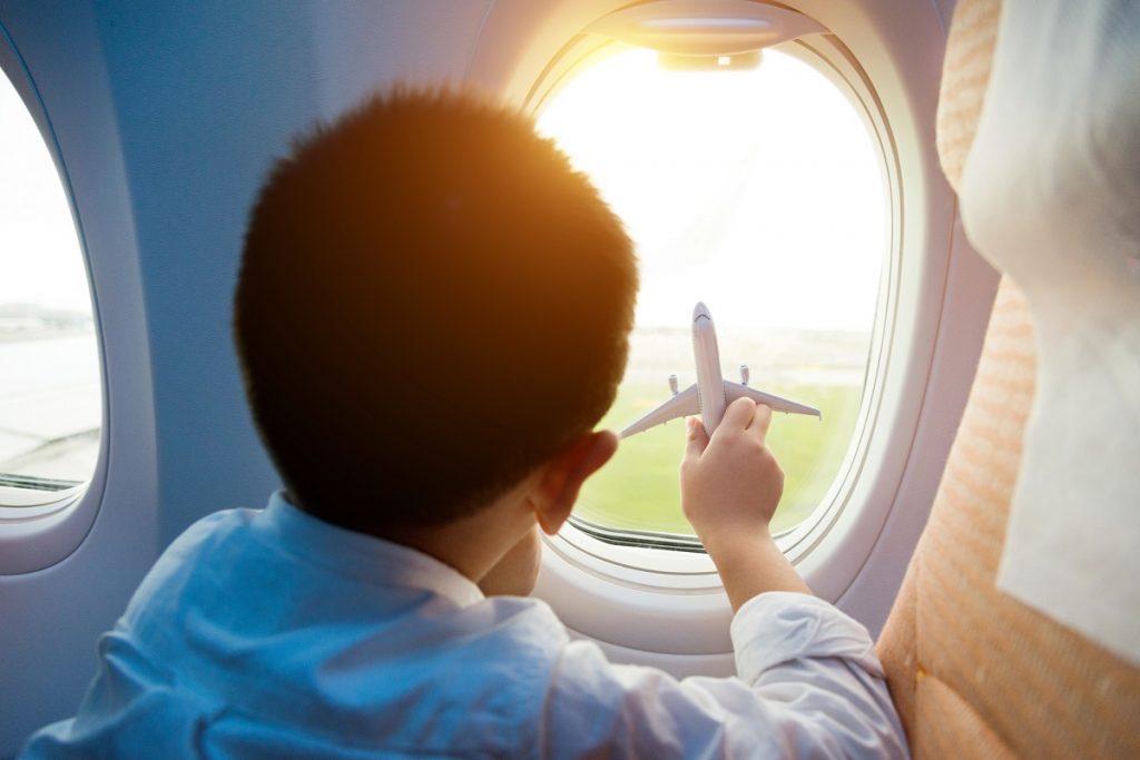 Little boy holding a toy plane