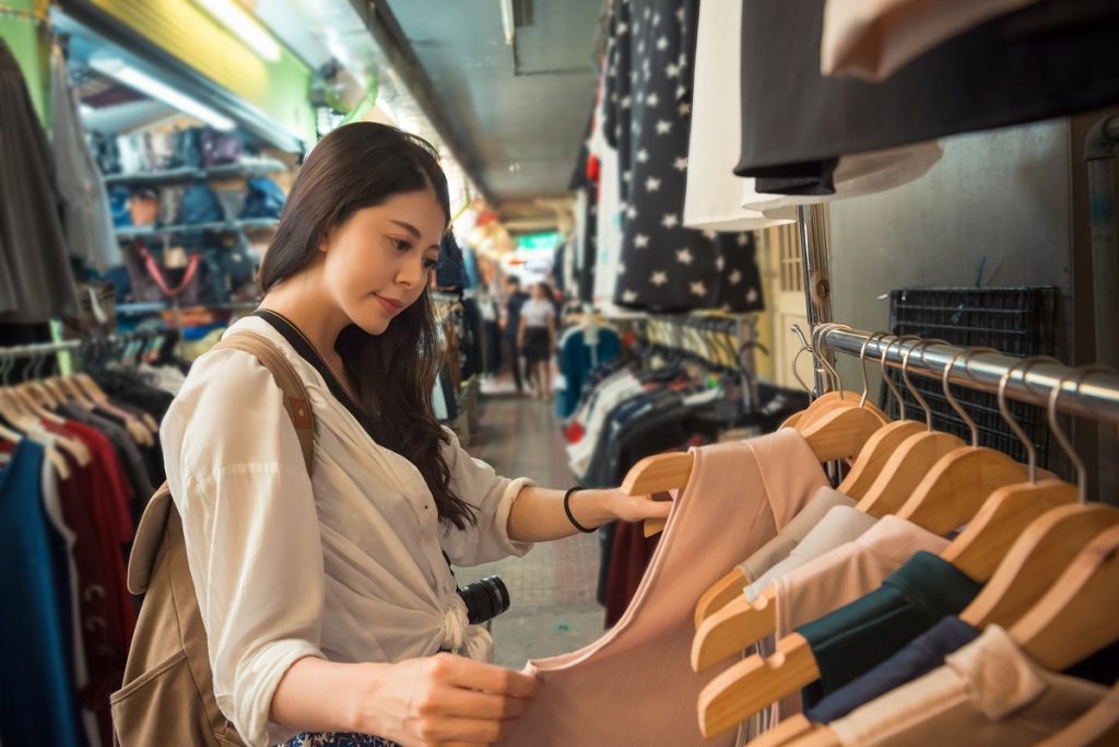 asian young woman shopping choosing clothing