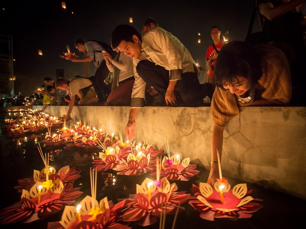 People float lanterns in the river during Loy Kratong festival